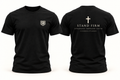 Stand Firm Tee — black shirt with small SB shield on front and cross with clean faith wording on back